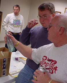 Donnie looks over one of Joel Young's bottles